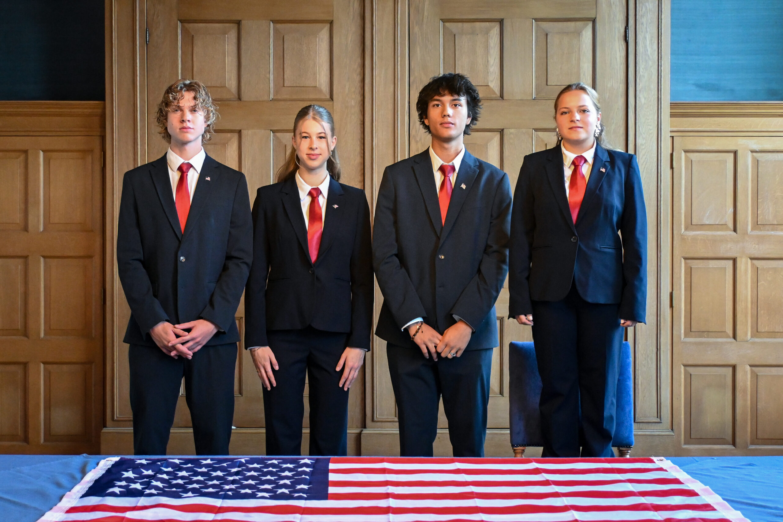 less serious picture standing same height with flag